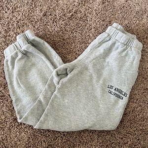 Brandy Melville grey joggers have Los Angeles California on top left, one size